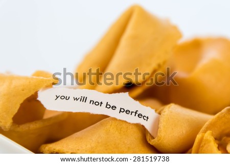 open fortune cookie with strip of white paper - YOU WILL NOT BE PERFECT