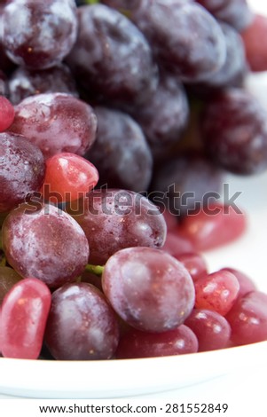 purple grapes vs purple jelly beans - snack decision between healthy food or junk food
