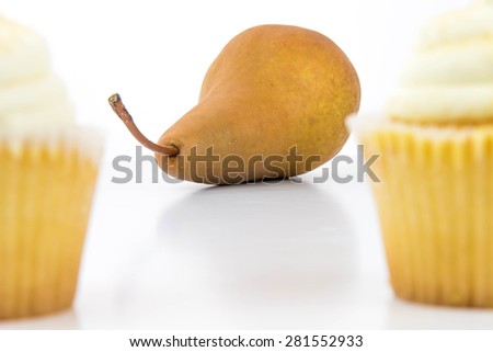 yellow pear vs yellow cupcake - snack decision between healthy food or junk food