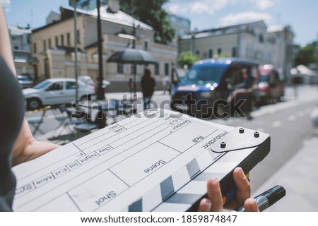 Assistant director with clapperboard on set. Close-up of firecrackers for filming a movie, advertising, TV series. Modern photography technique.
