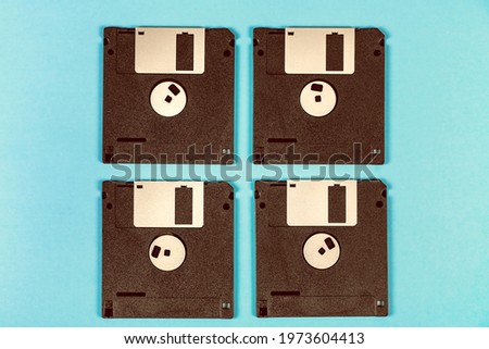 Toned Photo of Floppy Disks Drive Set on the Paper Background closeup