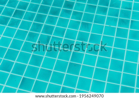 The blue texture of surface in the blue pool is clean, summer blue wave abstract or natural rippled water texture background, Swimming pool tile floor.