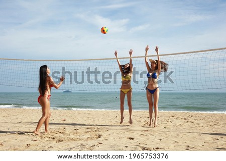 Happy and Funny women play volleyball on summer vacation , close friend have a funny time together on summer vacation