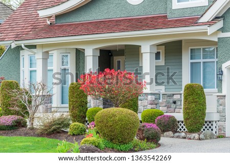 A perfect neighborhood. Houses in suburb at Spring in the north America. Fragment of a luxury house with entrance door and nice window.
