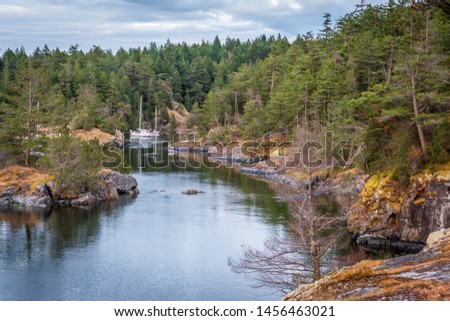 View over Inlet, ocean and island with boat and rocks in beautiful British Columbia. Canada.