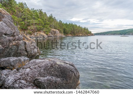 View over Inlet, ocean and island with rocks and mountains in beautiful British Columbia. Canada.