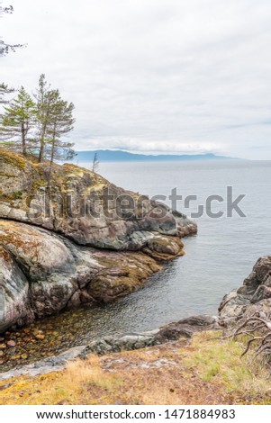 View over Inlet, ocean and island with boat and mountains in beautiful British Columbia. Canada.