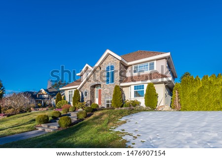 Houses in suburb at Winter in the north America. Luxury houses covered nice snow