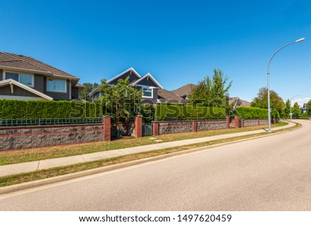 A perfect neighbourhood. Houses in suburb at Summer in the north America. Luxury houses with nice landscape.