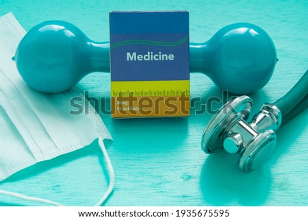 Medicine box, stethoscope and weight for physical exercise symbolizing mental balance at pandemic time
