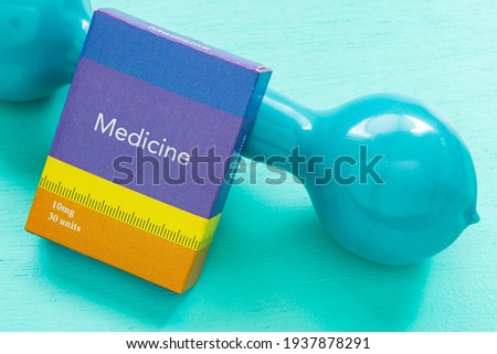 Medicine box and weight for physical exercise symbolizing mental balance