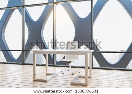 Clean office interior with panoramic city view and daylight, computer monitor, coffee cup and supplies on desktop. 3D Rendering