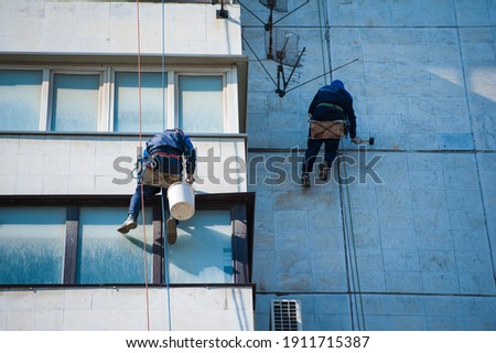 Climbers carry out construction and installation work on the facade of the building