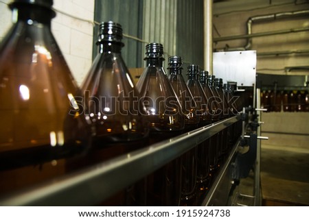 Food industry. Plastic bottles with a carbonated drink on the conveyor