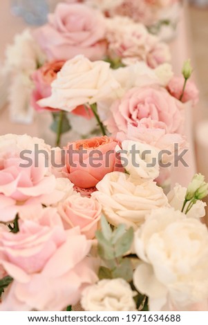 Lush floral arrangement of white and pink fresh flowers. Luxury wedding table decorations. Vertical photography