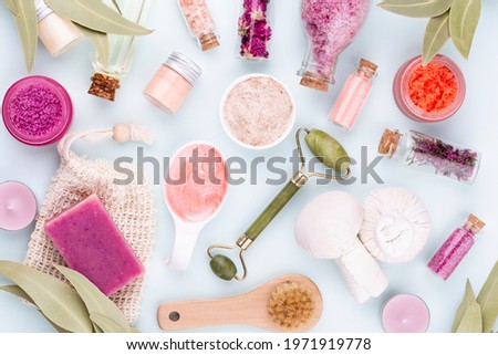 Spa and skin care homemade cosmetics. Bottles with spa cosmetic products on pastel background.