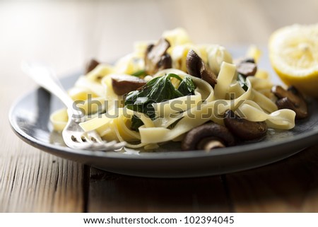 vegetarian dish with tagliatelles, spinach and mushrooms