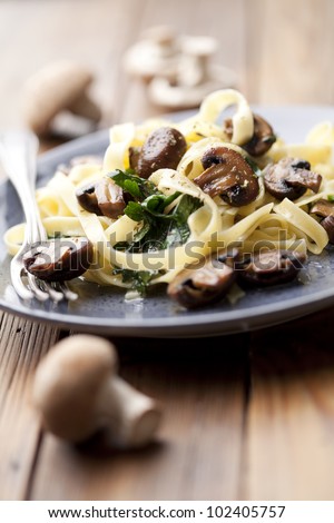 vegetarian dish with tagliatelles, spinach and mushrooms