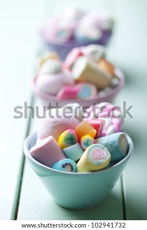 bowl full of colorful pastel marchmallows and rock candy