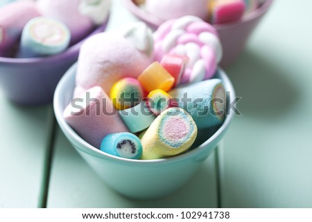 bowl full of colorful pastel marchmallows and rock candy