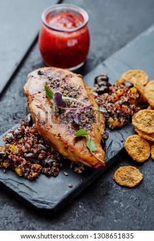 Grilled chicken breast with quinoa,black beans and banana chips and chili sauce