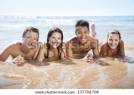group of young people having fun in the sea