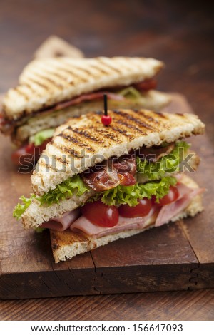 close up of fresh sandwich with ham, bacon,tomatoes,cheese and lettuce
