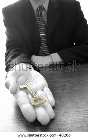 bw of businessman holding the golden key to success,