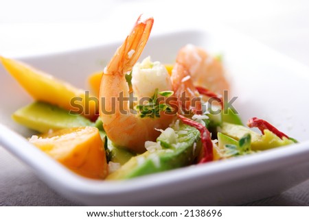 salad or apetizer with shrimp,coconut,avocado mango and herbs