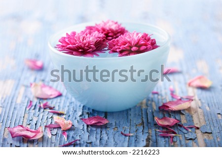 weathered wood with bowl of water and flowers