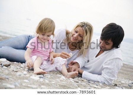 young family on the beach,focus is mainyly on the mothers face