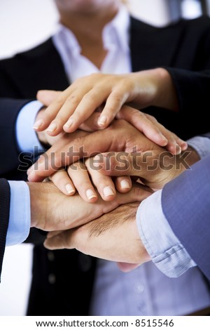 business people putting their hands on top of each other