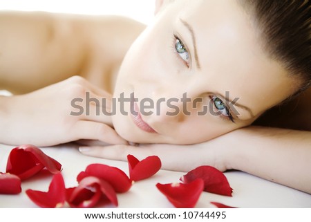 closeup of young beautiful female face, lying on a bed, maybe enjoying a beauty-treatment.