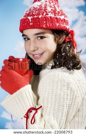  photo little girl in christmas colors with a red cup of something hot