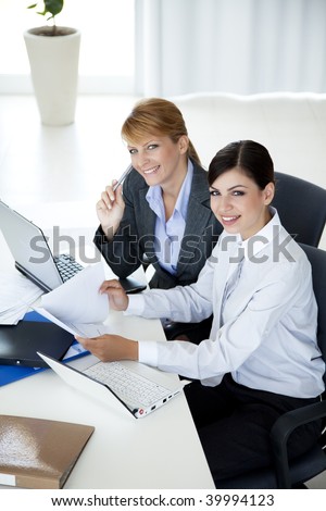 two young business women lookind at camera