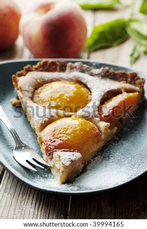 slice of homemade french peach tart, made with fresh poached peaches