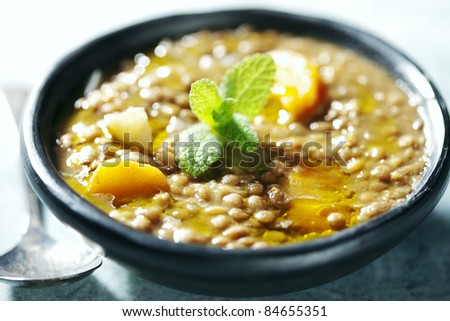 closeup of lentil soup, the lentils have cooked for 3 hours in order to form its own thick sauce, it also has carrots and onions