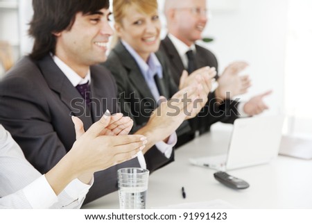 business team applauding at a conference or board meeting