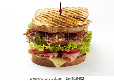 ham and bacon club sandwich on a white background