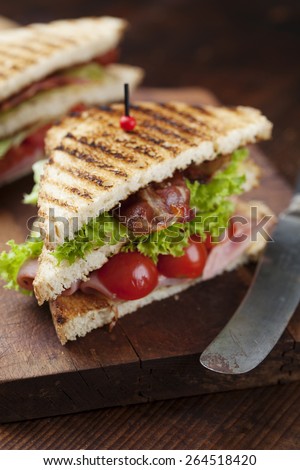 ham and bacon club sandwich on a white background
