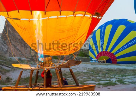 CAPPADOCIA, TURKEY - CIRCAR JUNE 2014 : Ground Crews torch the flame and heat up the balloon to inflate Hot Air Balloon before launching in circa June 2014