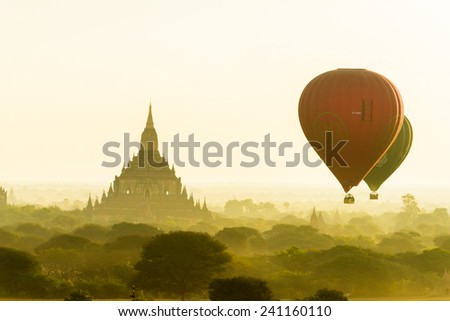 BAGAN, MYANMAR - CIRCA DECEMBER 2014 : Hot air balloons fly over Bagan, recognised as one the greatest ancient buddhism city, in circa December 2014 in Bagan, Myanmar.