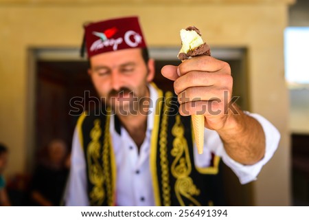 CAPPADOCIA, TURKEY - CIRCA JUNE, 2014: An ice cream seller, dressed in traditional Turkish costume. Cappadocia is one of the most popular destinations in the world.