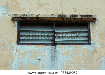Rusty window on wall with fungus