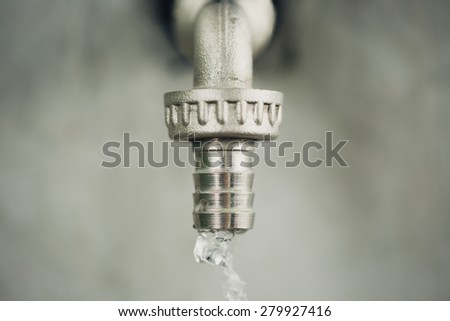Close up of water tap with water