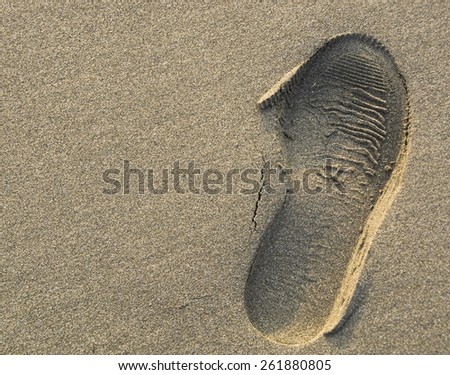 A shoe-print in the sand, suitable for backgrounds