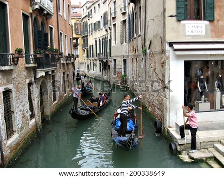 VENICE,ITALY - JUNE 1, 2011. Gondolas AND  gondoliers on the streets of Venice, Italy.