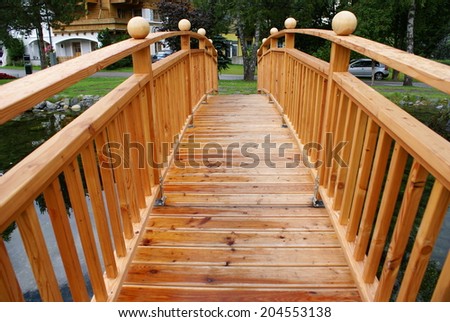 Pedestrian wooden bridge over the lake.