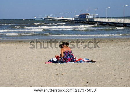 MAMAIA  BEACH, THE BLACK SEA, ROMANIA - SEPTEMBER 15, 2014. Autumn at the Black Sea. People relaxing on  the Beach Mamaia, Romania.