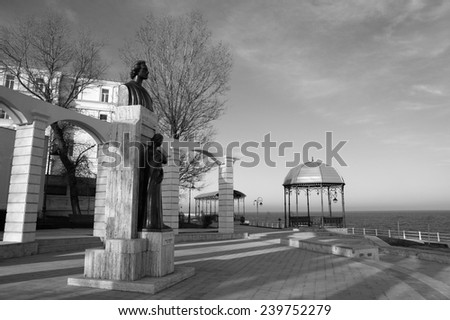 CONSTANTA, ROMANIA - DECEMBER 12, 2014. Winter day on the seafront at the Black Sea in Constanta,Romania .View of the Statue of Mihai Eminescu, great romanian writer, executed by sculptor Oscar Han .